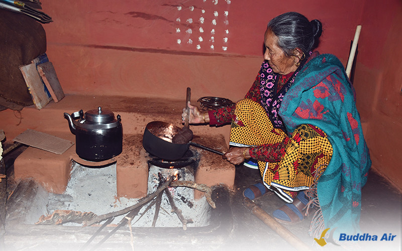 Mother cooking dhindo on local chulha